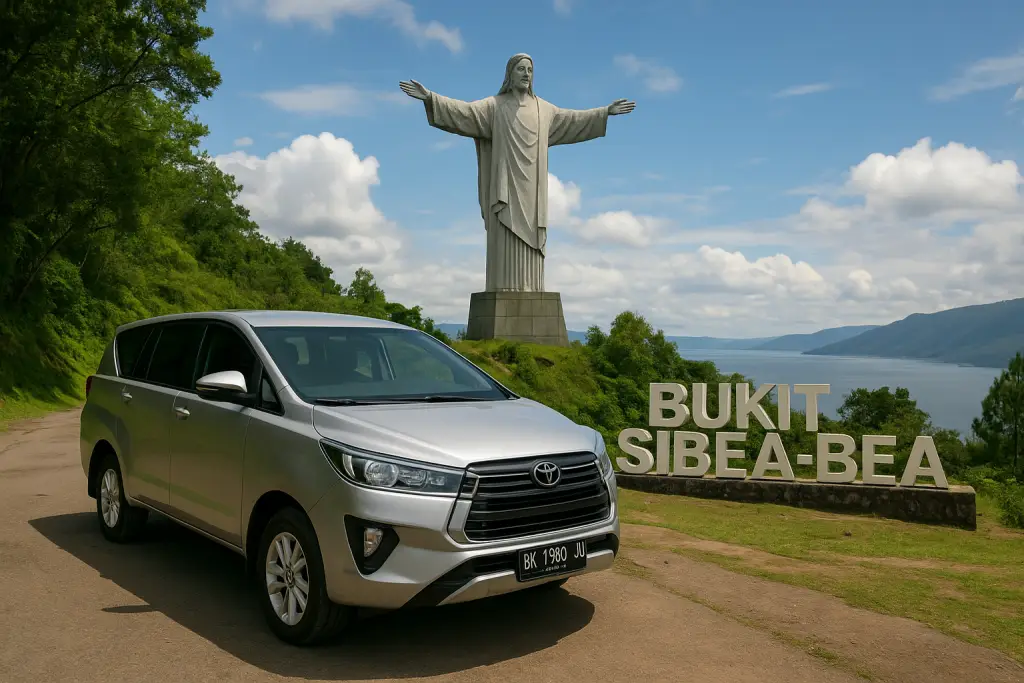 Rental mobil Toyota Innova di Bukit Sibea-bea Samosir dengan latar patung Yesus Kristus dan Danau Toba